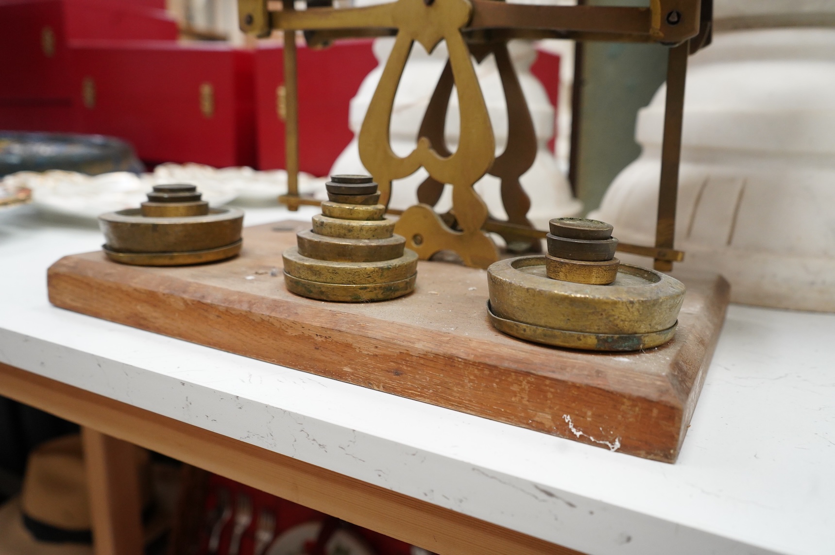 A set of brass and mahogany Avery postal scales and weights, 37cm wide